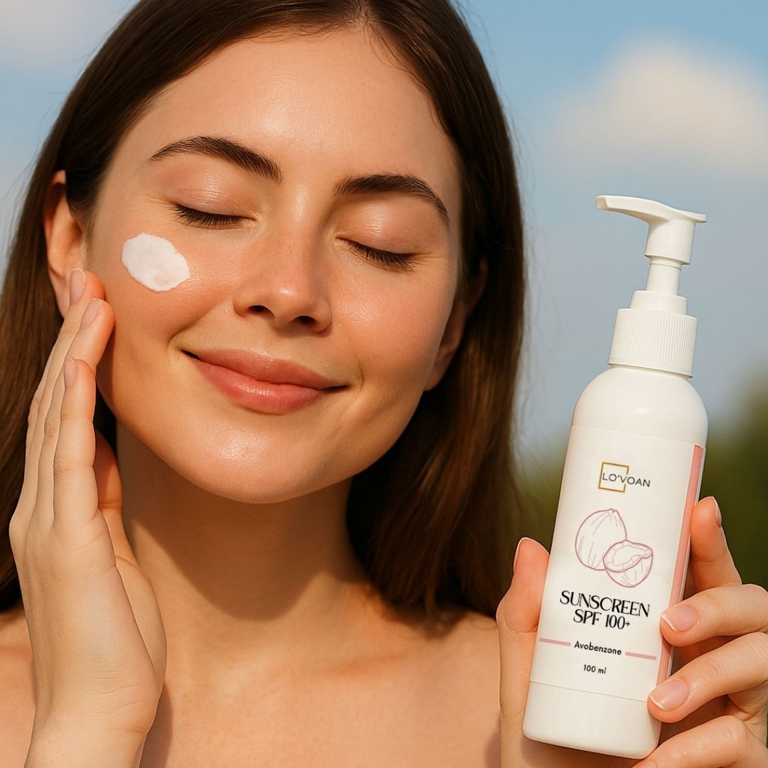 Woman applying sunscreen to her face with a bottle of LOVOAN sunscreen in her hand.